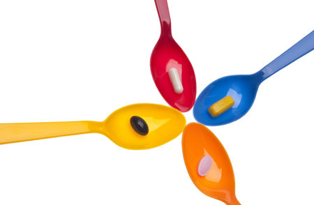 Spoonful of Pills to Keep Healthy Concept Image Isolated on White の写真素材