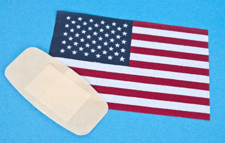 American Flag with Bandage for Concept of America Wounded.の写真素材