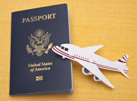 Cruise Ship, Airplane and American Passport on a Vibrant Yellow Background for a Travel Concept Image.の写真素材