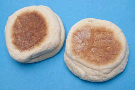 English Muffins on a Vibrant Blue Background.の写真素材