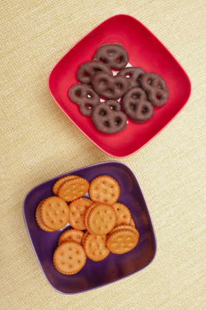 Two Small Bowls with Chocloate Covered Pretzels and Peantbutter Crackers, a Good Snack!の写真素材