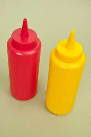Fun Ketchup and Mustard Bottles on a Green Background.の写真素材