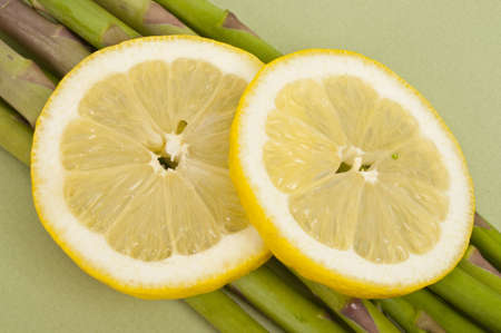 Lemon Silces over Fresh Asparagus, Close Up.の写真素材