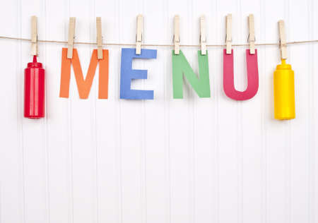 Vibrant Scene with the Word Menu and Ketchup and Mustard Bottles as the Focus on the Image.の写真素材