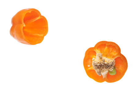 Vibrant Orange Pepper Sliced with Seeds Showing Isolated on Whiteの写真素材