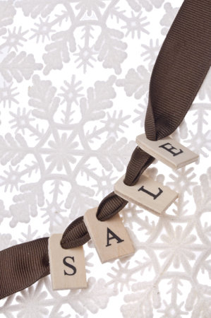 Holiday Sale Tag on a Snowflake Background.