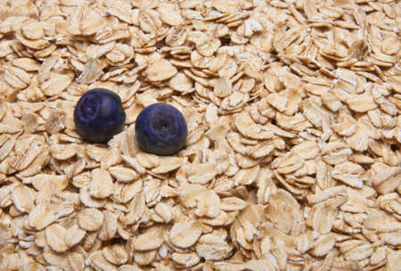 Fresh Whole Grain Oats and Blueberries Background.の写真素材