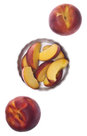 Sliced and Whole Fresh Peaches Isolated on White の写真素材