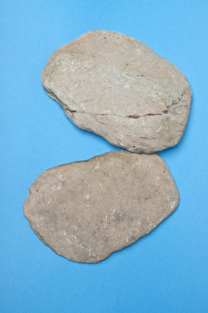 Smooth Natual River Rocks on a Blue Backgroundの写真素材