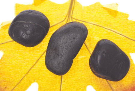 Zen Massage Stones on an Autumn Leaf Serene Fall Concept.の写真素材