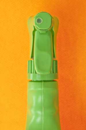 Close Up of Green Spray Nozzle on a Vibrant Orange Background.の写真素材