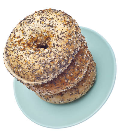 Everything Bagels Stacked on a Blue Plate.  Isolated on White の写真素材