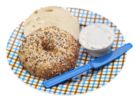 Everything Bagel with Cream Cheese and a Knife on a Plaid Plateの写真素材