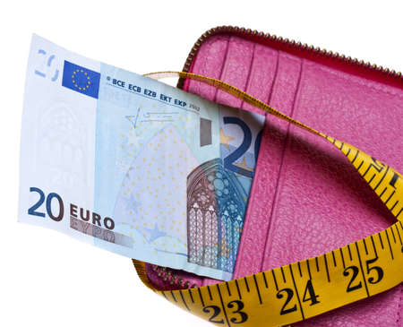 Tight Budget Concept with Open Wallet with Money Squeezed by a Measuring Tape.の写真素材