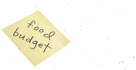 Sticky Note with Food Budget Written on It with Bread Crumbs Isolated on White.の写真素材