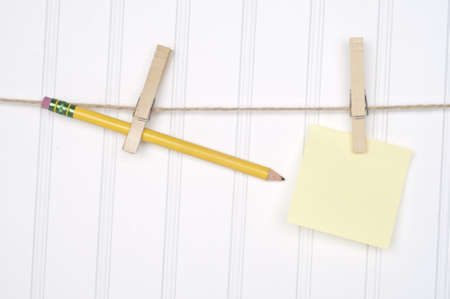 Creative Writing Concept with a Pencil and Blank Note Hanging on a Clothesline.の写真素材
