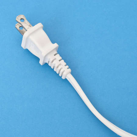White Plug and Cord on a Vibrant Backgroundの写真素材