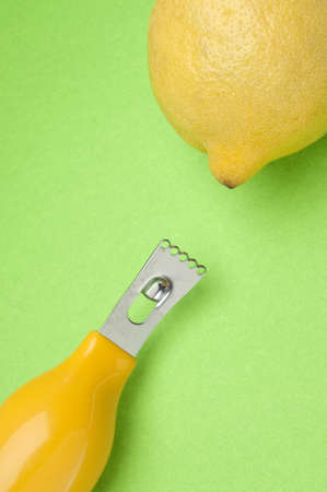 Lemon and Zester Close Up Image on Vibrant Green.の写真素材