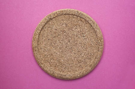 Cork Coaster on a Vibrant Pink Background.の写真素材
