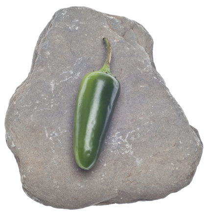 Jalapeno Pepper on a Rock Food Concept Isolated on Whiteの写真素材