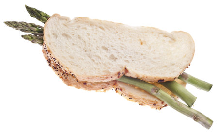 Vegetarian Sandwich Concept with Raw Asparagus Between Bread with Poppy and Sesame Seeds Isolated on White.の写真素材