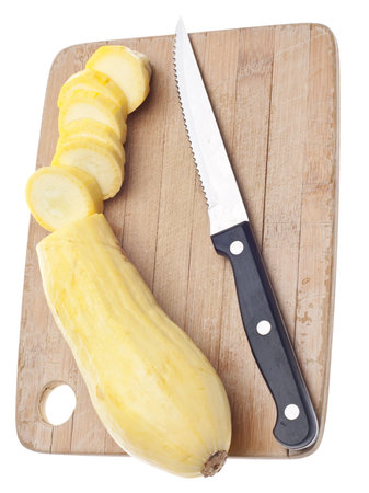 Sliced Yellow Squash on a Wooden Chopping Block Isolated on White の写真素材