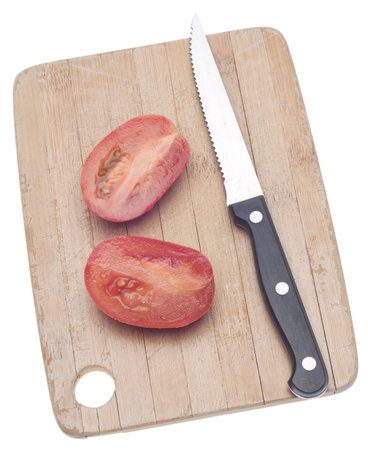 Sliced Roma Tomato on a Wooden Chopping Block Isolated on White