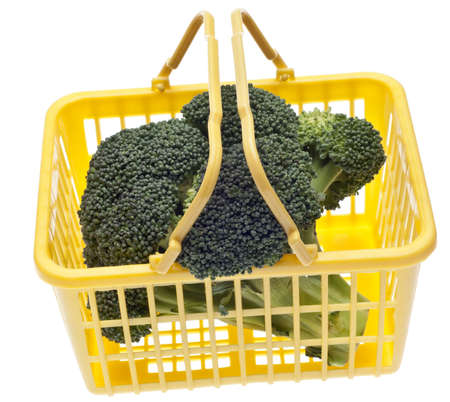 Fresh Broccoli in a Yellow Shopping Basket Isolated on White の写真素材