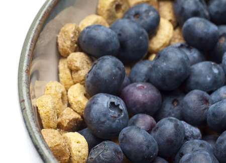 Close Up of Bowl of Cereal with Blueberries Covering Most of Cereal.の写真素材