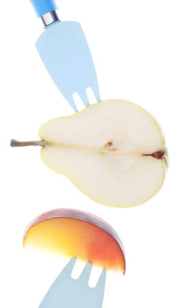 Sliced Fresh Pear and Nectarine on Vibrant Forks.の写真素材