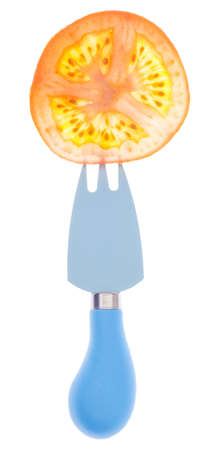 Juicy Tomato Slice Detail on Blue Fork Isolated on Whiteの写真素材