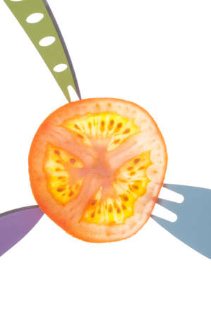Juicy Tomato Slice Detail Background with Vibrant Forks and Knives.の写真素材