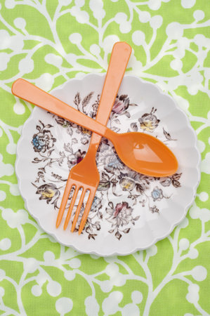 Modern Place Setting with Plate, Fork, Spoon and Fabric Background.