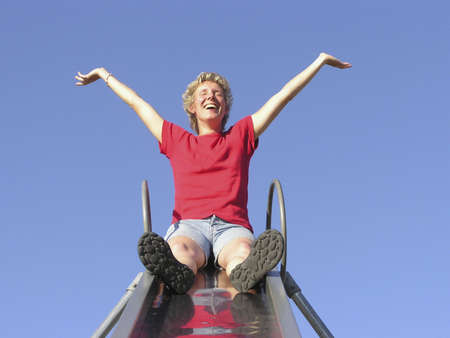 WOman on slide having funの写真素材