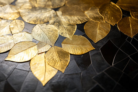 Golden leaves on a black background, close-up, selective focusの素材