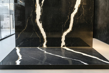 Black marble countertop in modern bathroom with marble wall and reflection.の素材