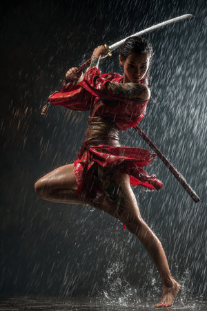 Beautiful Asian woman warrior with sword in the rain on dark backgroundの素材