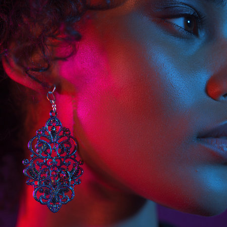 Close-up portrait of a beautiful African-American woman with silver earringsの素材