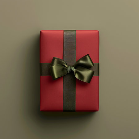 Red gift box with black bow on gray background. Top view.の素材
