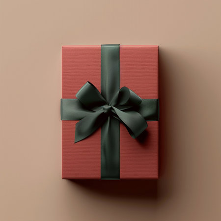 Red gift box with green bow on beige background, top viewの素材