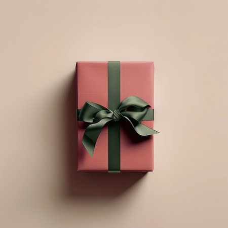 Gift box with green bow on beige background, top viewの素材