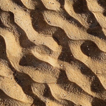 Closeup of sand pattern on a beach in a sunny summer dayの素材