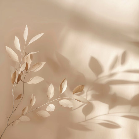 Minimalist abstract background with golden leaves and shadows on a beige background.の素材