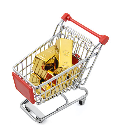 Gold bar in shopping cartの写真素材
