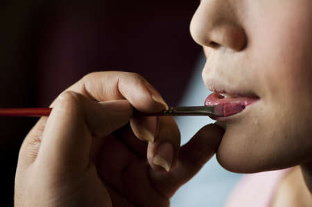 Close up of beautician makeup for a young womenの写真素材