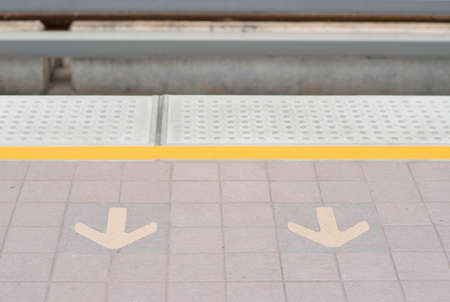 Arrow on train station platform floorの写真素材