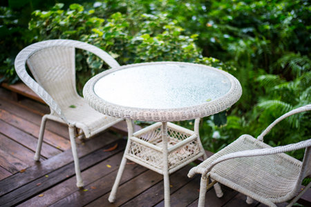 Patio table and chairs in a tropical gardenの写真素材