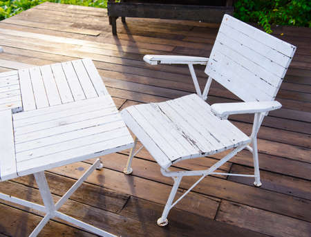 Empty white garden chair and tableの写真素材