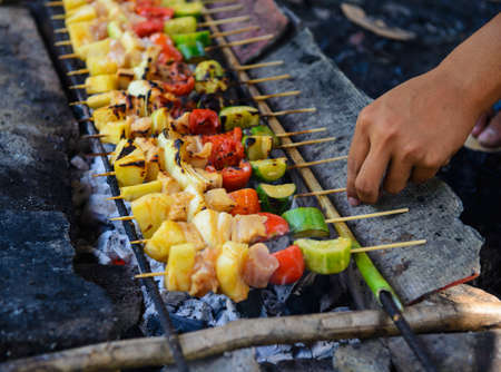 Man grilling barbecue for partyの写真素材