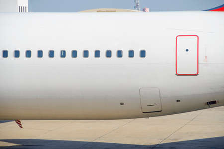 Windows and exit door of an airplane side viewの写真素材